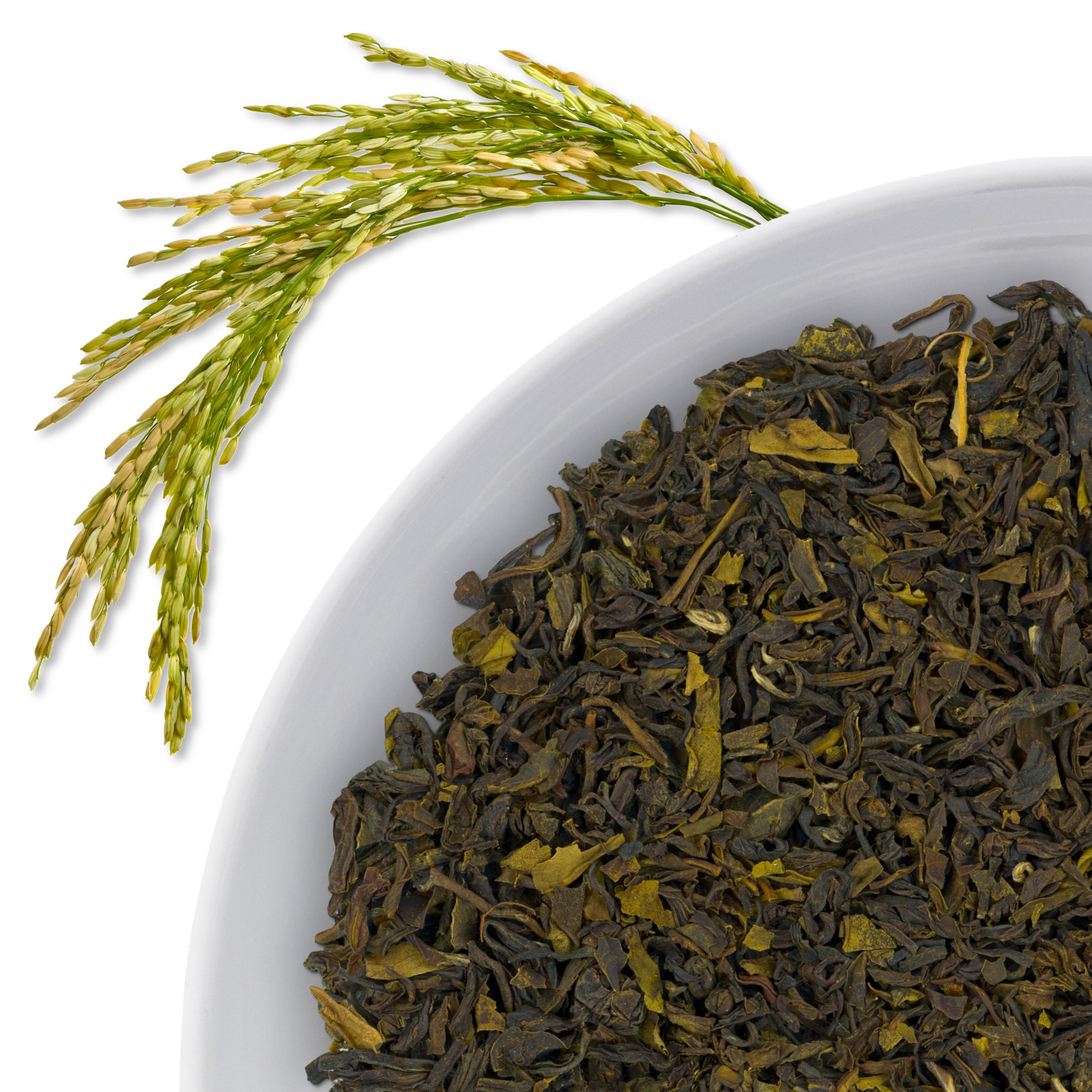 The corner of a bowl of Assam Valley loose leaf green tea, with flavor notes displayed as rice-flavored through the use of a long rice frond.