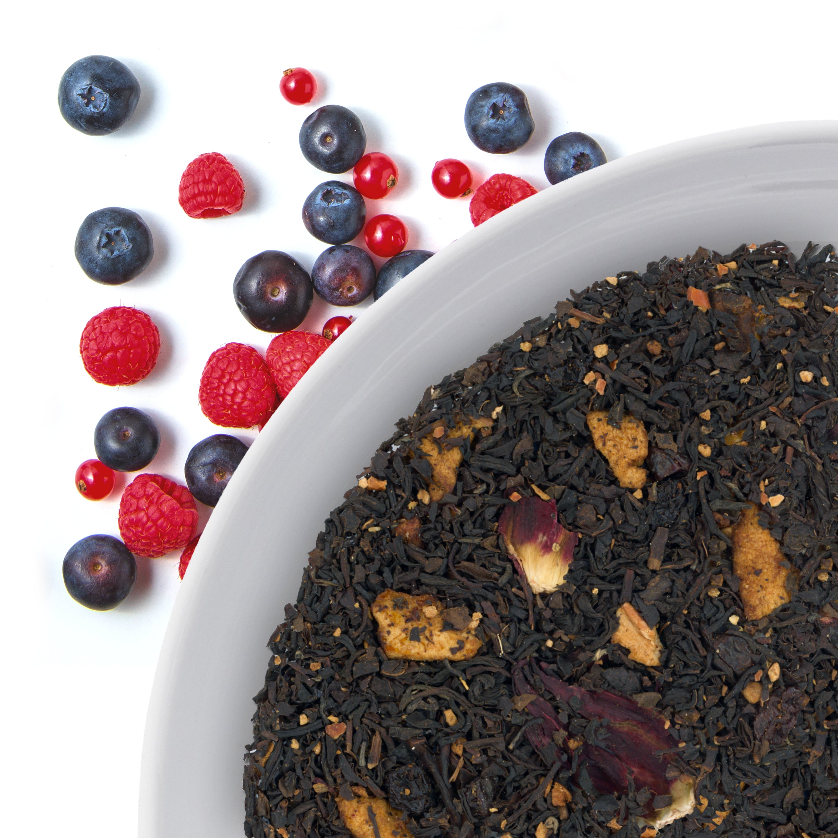 The corner of a bowl of Berry Bliss loose leaf black tea, with flavor notes displayed as mixed forest berries.