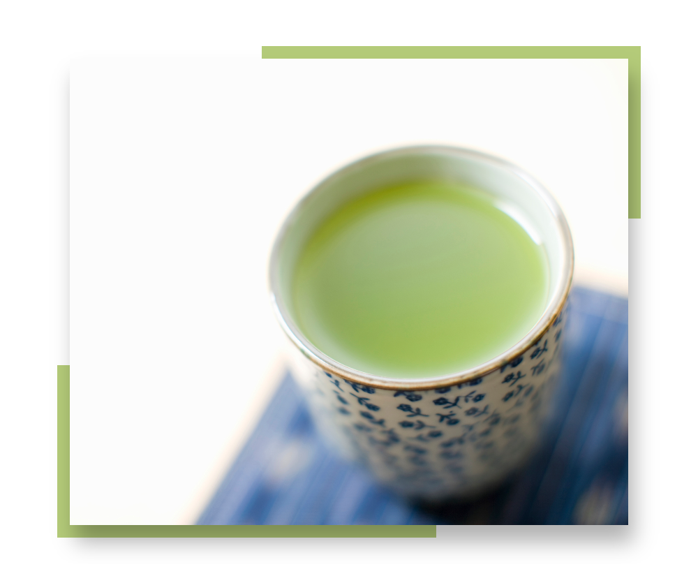 A porcelain cup of green tea, bordered by green accent colors.