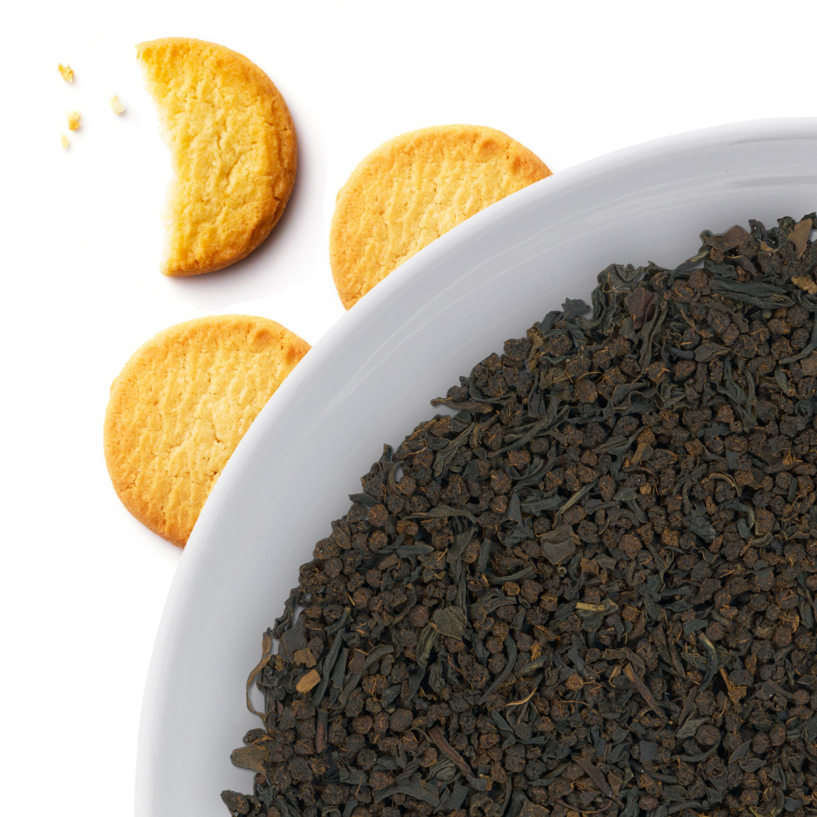 The corner of a bowl of Malty Breakfast loose leaf black tea, with flavor notes displayed as breakfast cookies.