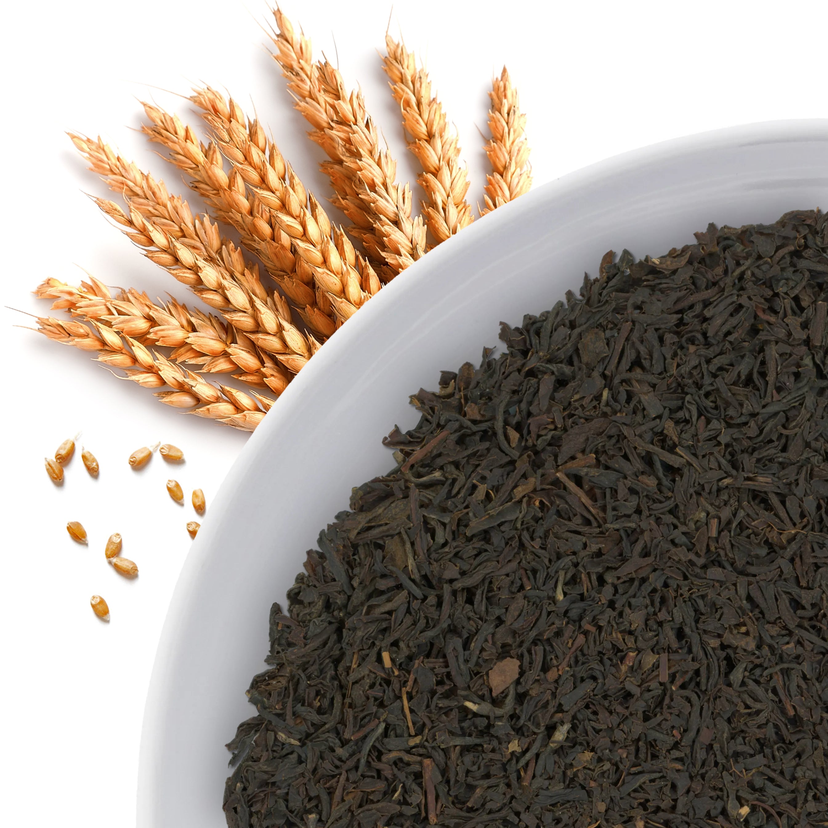 The corner of a bowl of Sibbari Estate loose leaf black tea, with flavor notes displayed as malt grains.